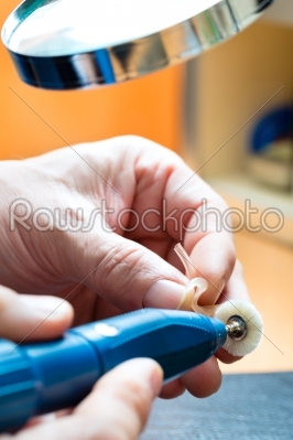 Acoustician working on a hearing aid