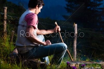 Alps - Man at campfire in Bavarian mountains