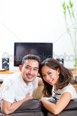 Asian couple at home in their living room