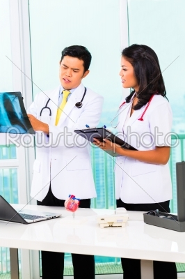 Asian doctor and nurse in surgery