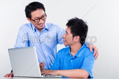 Asian father and son learning at home for school