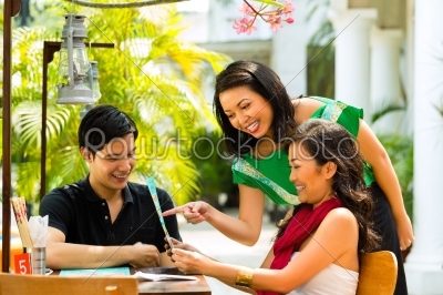 Asian man and woman in restaurant