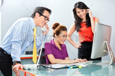 Asian office team working hard for a business success