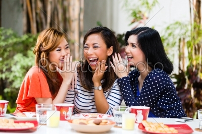Asian women gossiping about things