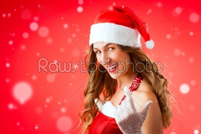 Attractive young woman in Santa Claus costume alluring gesture