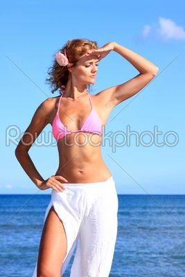 Beautiful young woman by the sea