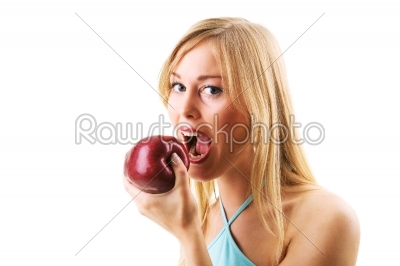 Blonde woman eating juicy apple