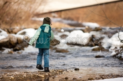 Boy with snow on river