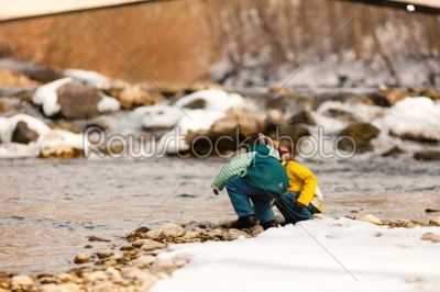 Boys with snow on river in Winter