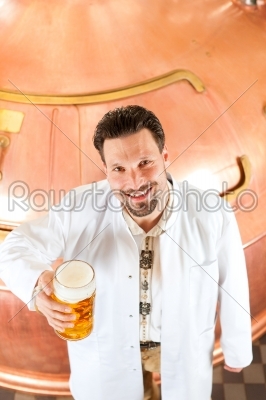 brewer with beer glass in brewery