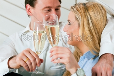 Business Couple at home with champagne