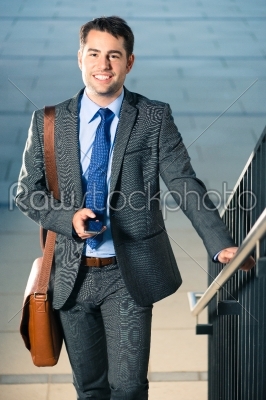 businessman walking using phone