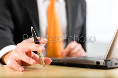 businessperson with laptop in his business office