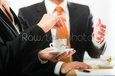 businesspersons in business office drinking coffee