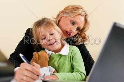 Businesswoman and mother is working at home