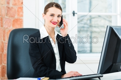 businesswoman in office sitting on the computer