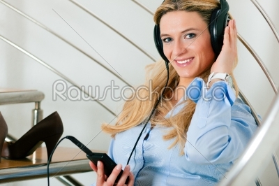 Businesswoman making a phone call at home
