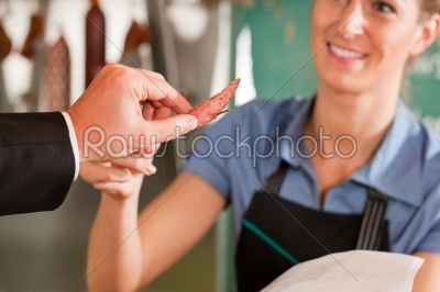 Butcher Giving Chopped Piece of Meat to Customer