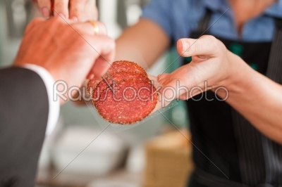 Butcher Showing Fresh Meat Steaks to Customer