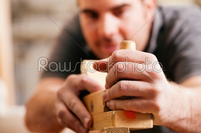 Carpenter with wood planer