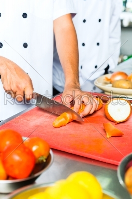 Chef in restaurant kitchen cooking