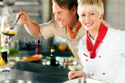 Chefs in a restaurant or hotel kitchen cooking
