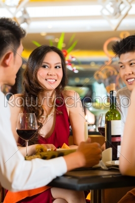Chinese business people dining in elegant restaurant