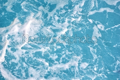 Clean blue sea water with foam