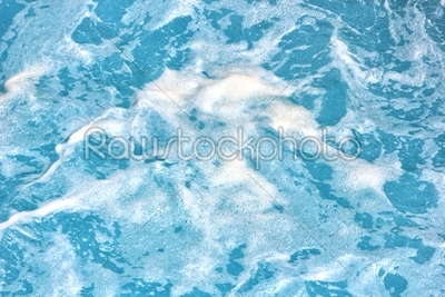 Clean blue sea water with foam