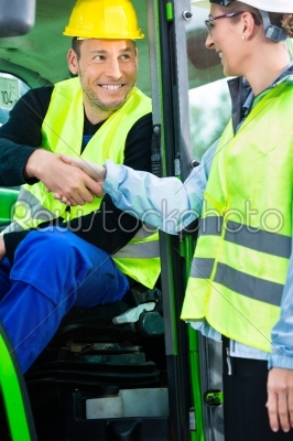 Construction worker hand shake with engineer on construction sit