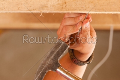 Construction worker with hammer and nail 