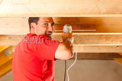 Construction worker with hand drill