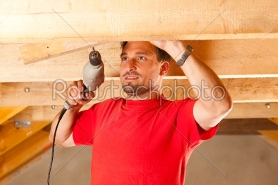 Construction worker with hand drill