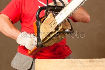 Construction worker with motor saw