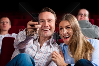 Couple and other people in cinema