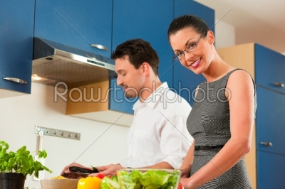 Couple cooking together in kitchen