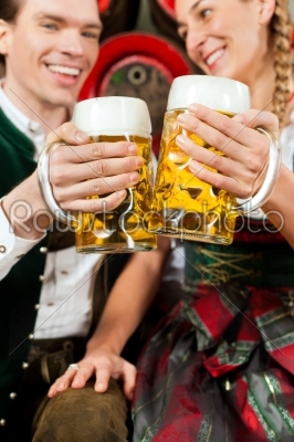 Couple drinking beer in brewery
