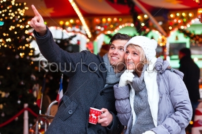 Couple drinking spiced wine on Christmas market