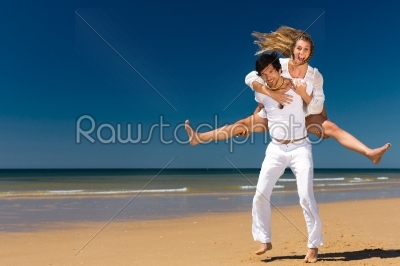 Couple enjoying freedom on the beach