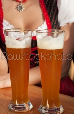 Couple in Bavarian Tracht clinking glasses 