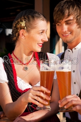 Couple in Bavarian Tracht drinking wheat beer