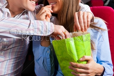 Couple in cinema theater with popcorn