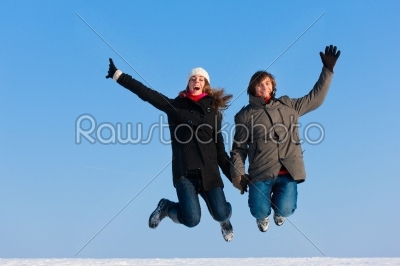 Couple jumping on a winter day