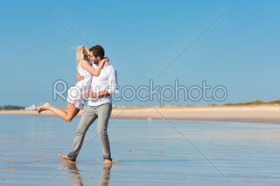 Couple on the beach running into glorious future