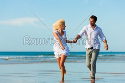 Couple on the beach running into glorious future