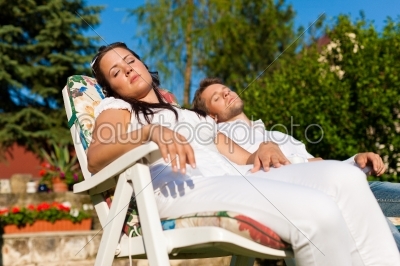 Couple resting in deck chair in summer
