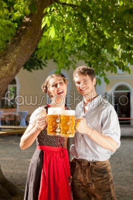 Couple with beer stein and traditional clothes