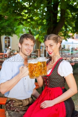 Couple with beer stein and traditional clothes