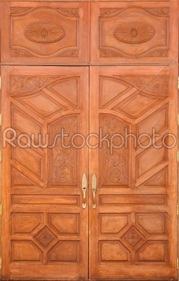 crafted wood door at Buddish temple in Thailand