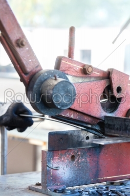 Craftsman cutting Metal with shear
